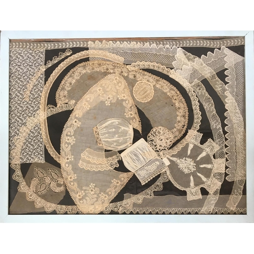 519 - Various items of lace and white work displayed within a frame, 74x98cm