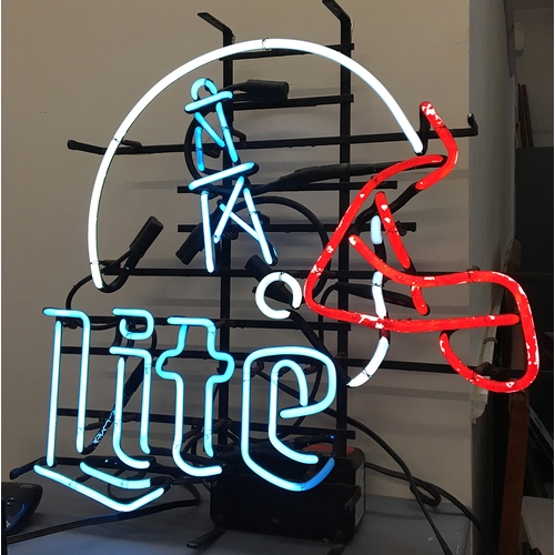 170 - An American neon bar sign 'LITE' below an American football helmet, with a 'step down and step up vo... 