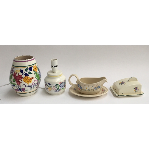47 - A Poole Pottery 'Springtime' gravy boat and stand; vase, 20.5cmH; Poole Pottery lamp; and a Poole Po... 