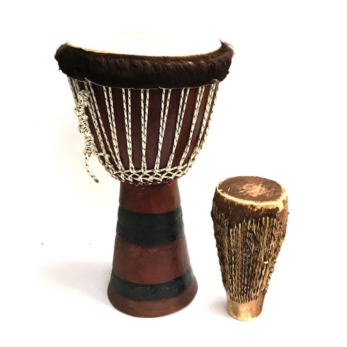 154 - A large hide drum, 62cmH; together with one other smaller, approx. 32cmH