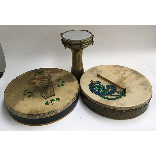 155 - A Turkish metal drum; together with two Irish bohdrans
