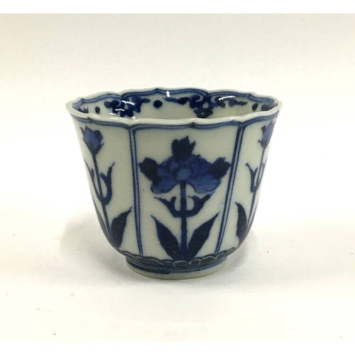 34 - A Japanese blue and white porcelain tea cup, floral panelled design, marked to base, approx. 7cmH