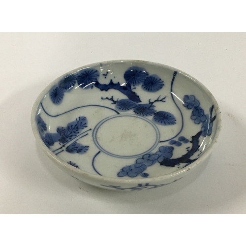 35 - A small Japanese porcelain plate, blue and white with lucky charm plant and bamboo design, marks to ... 