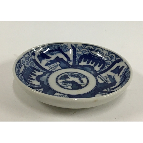36 - A Japanese Kozara porcelain blue and white plate, Seigaiha pattern, marks to base, 11cmD