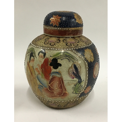38 - A Japanese Satsuma ginger jar, crackle glazed with textured enamel dot finish and moriage applicatio... 