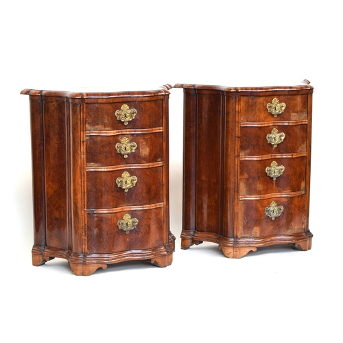 633 - A pair of 18th century German Rococo side cupboards, shaped and serpentine form, each with four grad... 