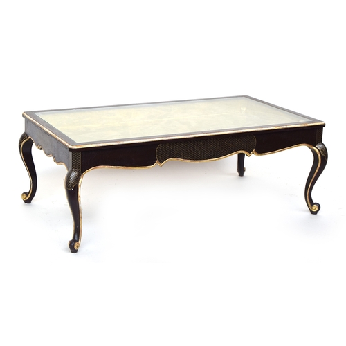 647 - A 20th century ebonised and parcel gilt coffee table, glass inset top with gilt interior, raised on ... 