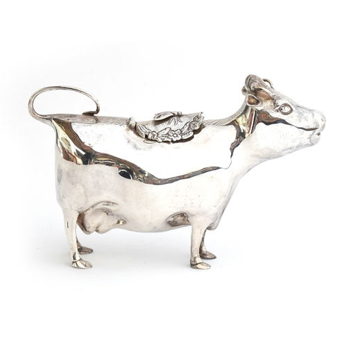 67 - A 20th century silver cow creamer by William Comyns & Sons Ltd, London 1970, modelled as a standing ... 