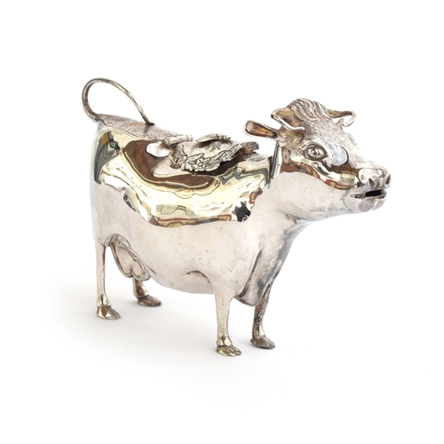 67 - A 20th century silver cow creamer by William Comyns & Sons Ltd, London 1970, modelled as a standing ... 