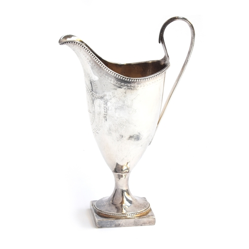 64 - A George III silver helmet form milk jug, John Robins, London 1784, with beaded rim, bright cut deco... 