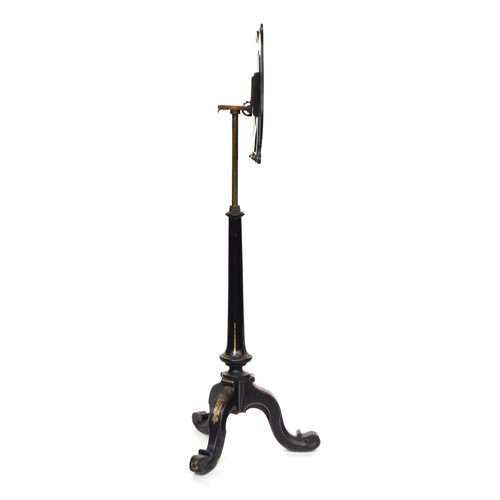 593 - A Victorian ebonised music stand by Jennens & Bettridge, the lyre form top with armorial crest depic... 