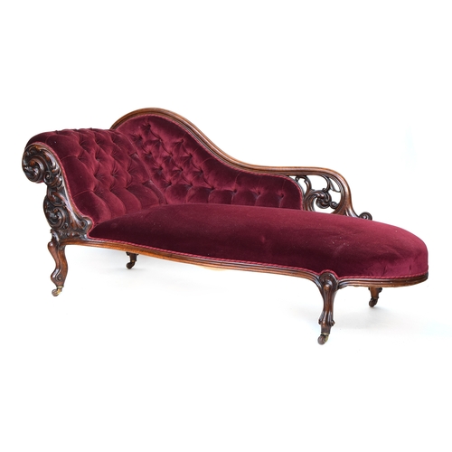 628 - A Victorian chaise longue, button upholstered, on a carved mahogany frame