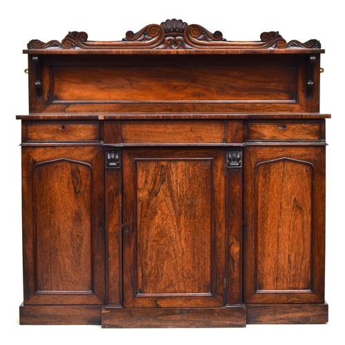 636 - A 19th century break front rosewood chiffonier, carved upstand with single shelf, central fitted dra... 