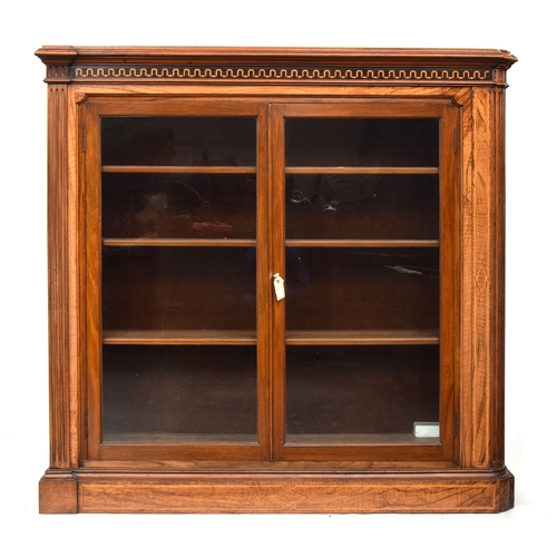 603 - A 19th century glazed bookcase of four shelves, moulded pediment over marquetry frieze, one end late... 