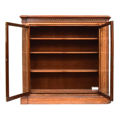 603 - A 19th century glazed bookcase of four shelves, moulded pediment over marquetry frieze, one end late... 