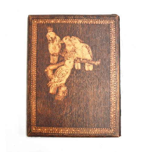 155 - An unusual early 20th century wooden notepad cover decorated with pyrography designs of cockatiels, ... 