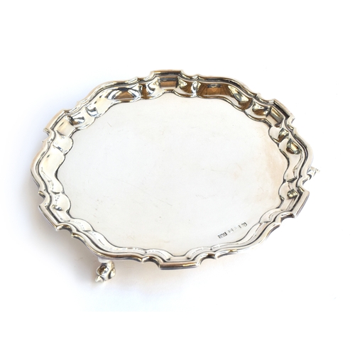 94 - A silver salver by Viners, Sheffield 1938, of shaped circular form with pie-crust rim raised upon th... 