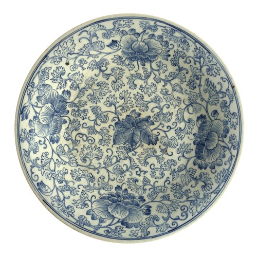 184 - A large Chinese export blue and white charger, profusely decorated with interlocking chrysanthemums,... 