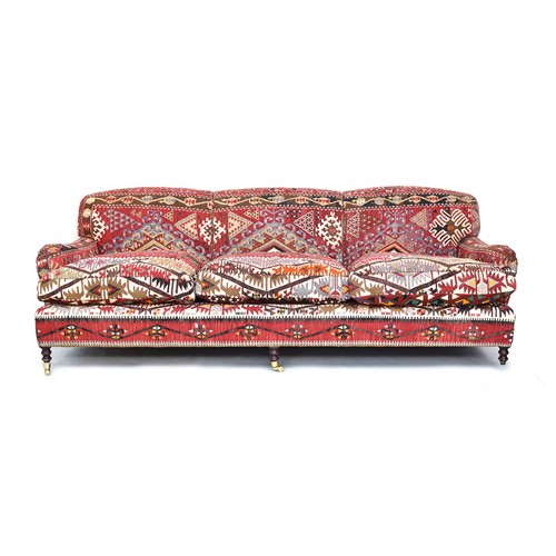 630 - A substantial George Smith three seater sofa, upholstered with kilim, approximately 245cm wide