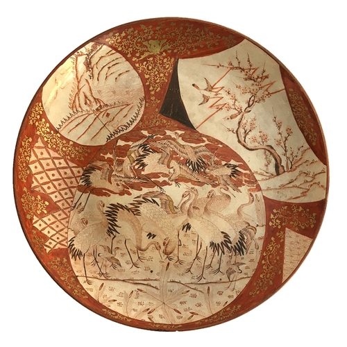 185 - A large Japanese Meiji period satsuma plate, decorated with three shaped panels depicting cranes, a ... 