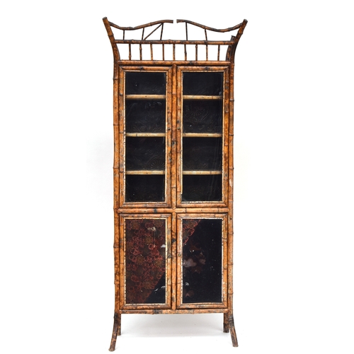 638 - A Victorian tiger bamboo display cabinet, comprising a pair of glazed doors over a further pair of p... 