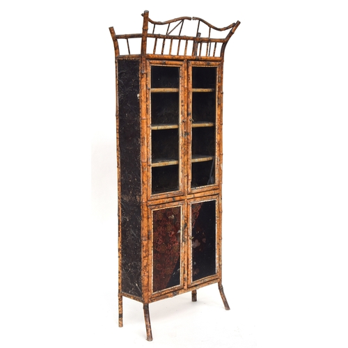 638 - A Victorian tiger bamboo display cabinet, comprising a pair of glazed doors over a further pair of p... 