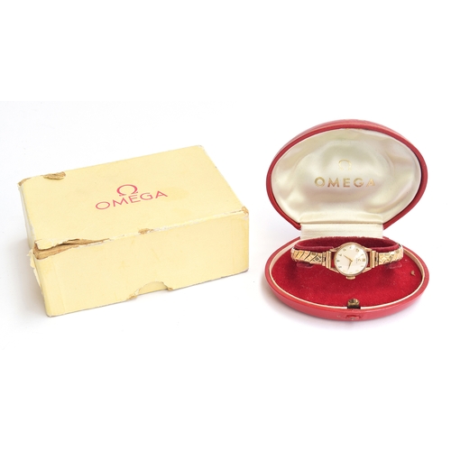 41 - A ladies gold Omega watch on yellow metal bracelet. In original box and with paperwork