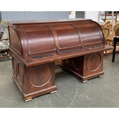 557A - A substantial Anglo-Indian rolltop desk, containing numerous fitted pigeonholes and drawers, over a ... 