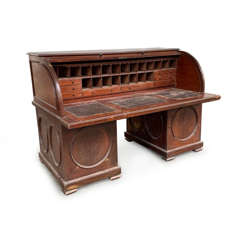 557A - A substantial Anglo-Indian rolltop desk, containing numerous fitted pigeonholes and drawers, over a ... 