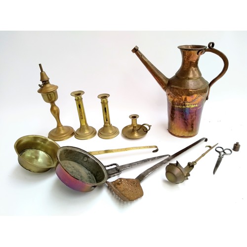 134 - A mixed lot of brass and copper items to include watering can; candlesticks; pans; hanging candle ho... 