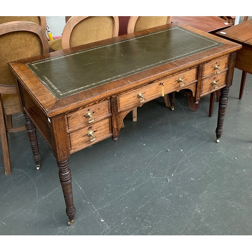 452 - A late 19th century walnut writing desk, by James Shoolbred & co., leather inset top, over five draw... 