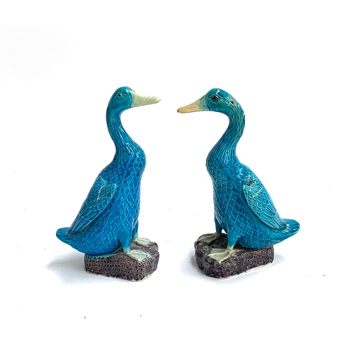 75 - A pair of Chinese ceramic blue glaze duck figures, one af, 21cmH