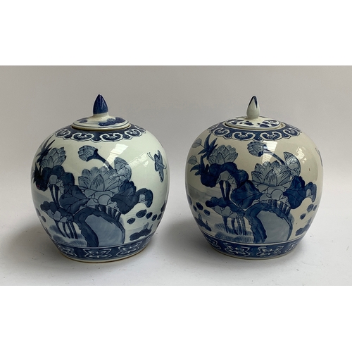 90 - A matched pair of Chinese blue and white urns, with lotus decoration, marked to base, each 25cmH