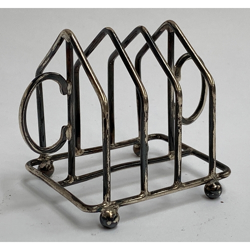 13 - A small silver three division toast rack, hallmarked Birmingham, 1922