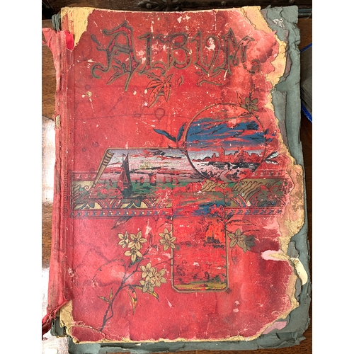 250 - A late 19th/early 20th century scrapbook; together with a postcard album with a number of black and ... 