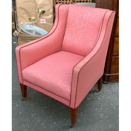 553 - A small Edwardian armchair, upholstered in a pink fabric, on inlaid tapered legs and casters