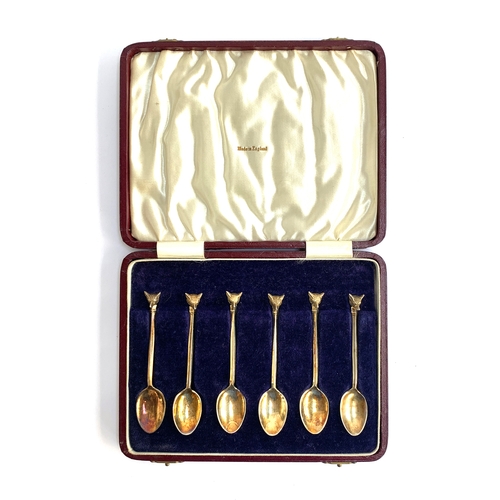 83 - A cased set of six silver gilt coffee spoons with fox mask terminals, retailed by Swaine & Adeney, B... 