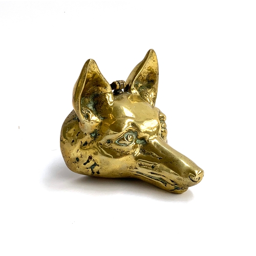 102 - A 19th century brass fox mask door stop, 16cm high