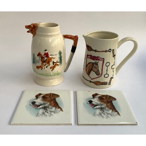 104 - A pair of hunting related ceramic jugs; together with two T&R Boote ceramic tiles of terriers, each ... 