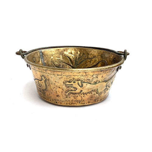 109 - A 19th century copper and brass pan, chased with gundog, pheasant, etc, 25cm diameter