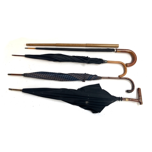 207 - A gent's umbrella with collapsible telescopic outer cover; together with one other by James Clarke, ... 