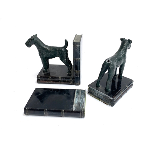 121 - A pair of bronze and cast metal book ends, in the form of standing fox terriers, 13cm high, one with... 