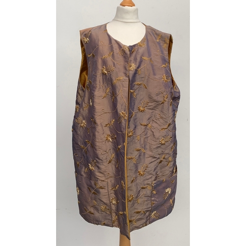 904 - A black silk and zodiac sign over jacket, size 8; together with a reversible silk gilet