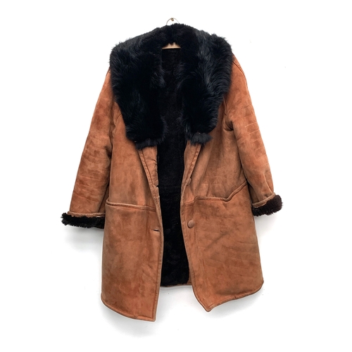 907 - A brown sheepskin coat, with black fur collar