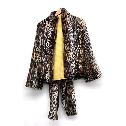 909 - An M. Camozzi faux leopard skin trouser suit, with wool lining, the trousers with zipped ankles; tog... 