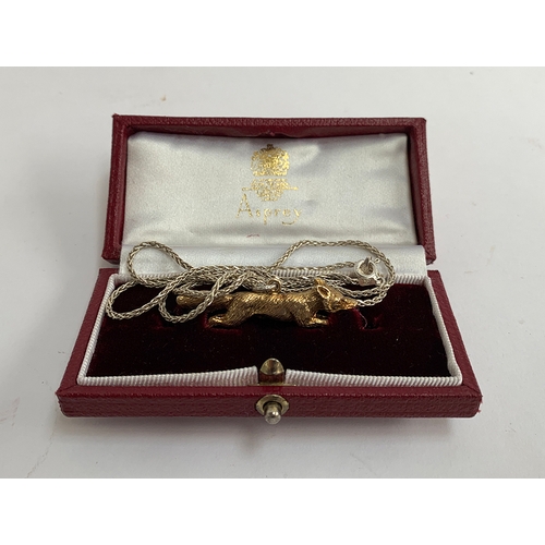 76 - An Asprey 9ct gold running fox, on a .925 silver chain, marked London 1967, approx. 6.9g