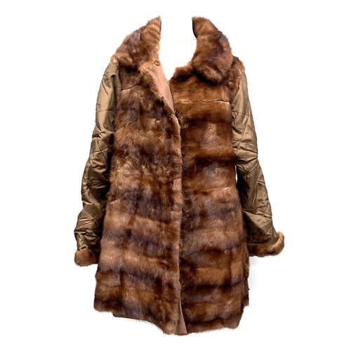 910 - A ladies fur coat with quilted sleeves, approximately size 10