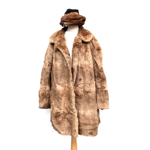 911 - A ladies rabbit fur coat by Regency; together with a hat with velvet rosette; and one other