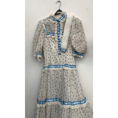 912 - A late 20th century coming out dress, made by Regamus, with a silk tie