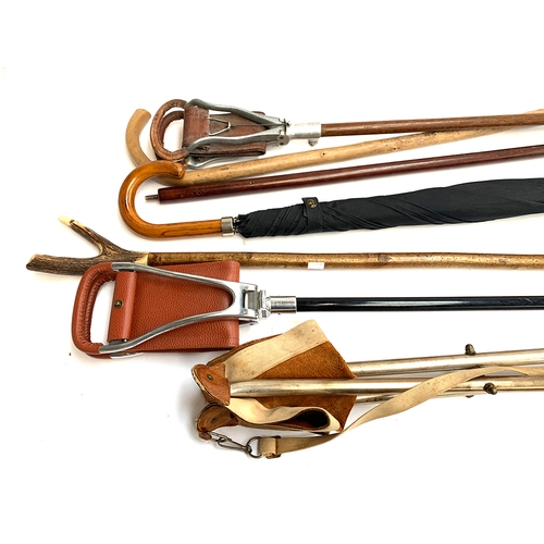 206 - A Gamebird shooting stick and one other; thumb stick; umbrella, etc (7)
